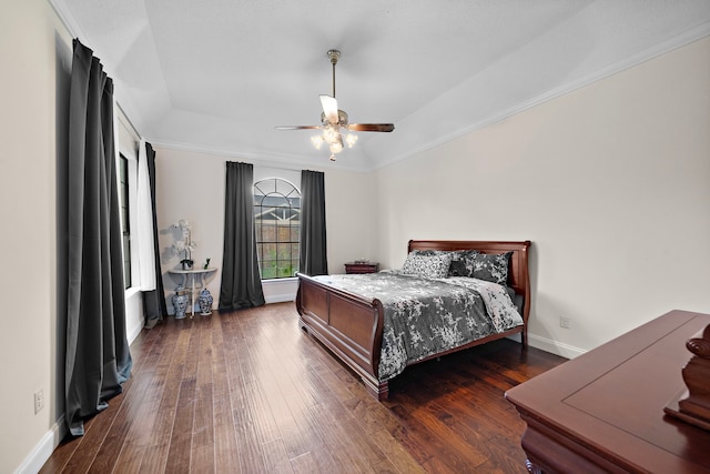 bedroom featuring ceiling fan, dark hardwood / wood-style flooring, and crown molding