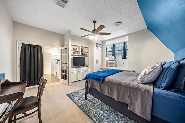 carpeted bedroom featuring vaulted ceiling, ceiling fan, and a textured ceiling