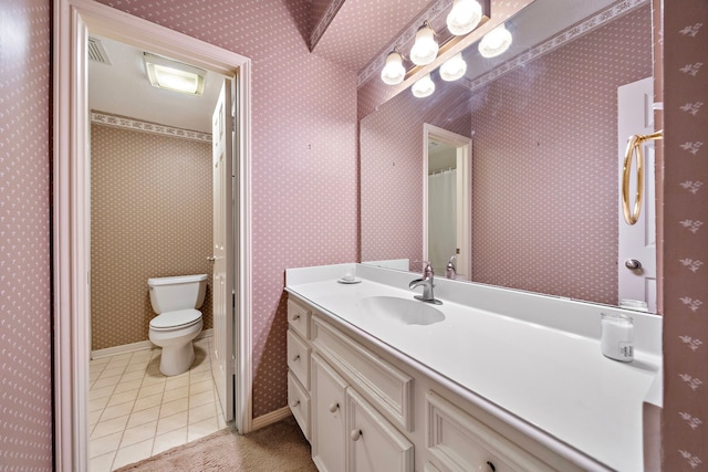 bathroom featuring tile patterned floors, vanity, and toilet