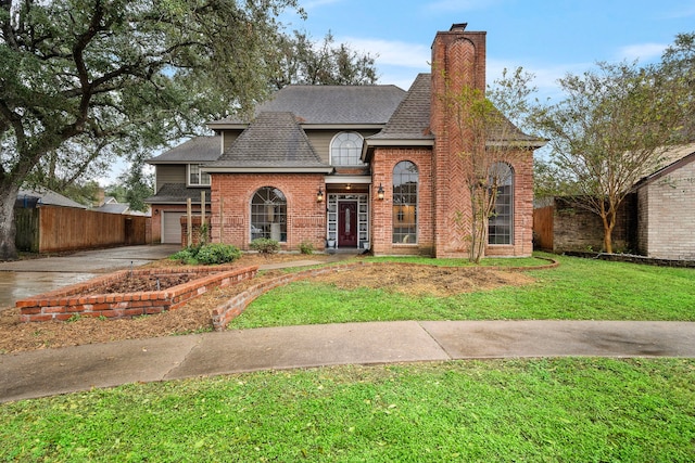 view of front of property featuring a garage and a front lawn