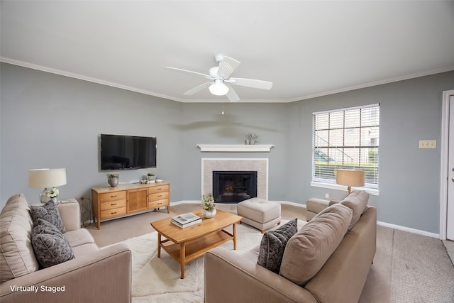 living room with a tiled fireplace, light carpet, ceiling fan, and ornamental molding