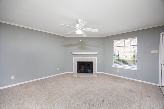 unfurnished living room featuring ceiling fan, ornamental molding, light carpet, and a tile fireplace