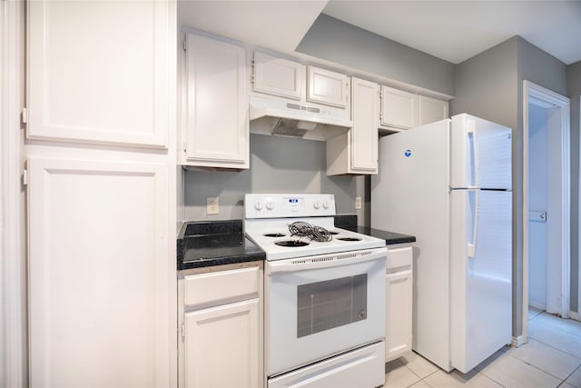 kitchen with light tile patterned floors, white cabinets, and white appliances