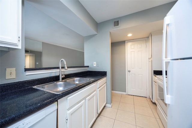 kitchen featuring white cabinetry, sink, light tile patterned floors, and white appliances