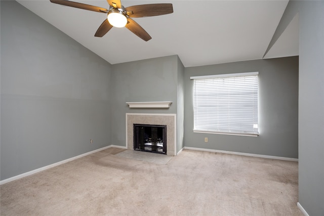 unfurnished living room featuring light colored carpet, a fireplace, and vaulted ceiling