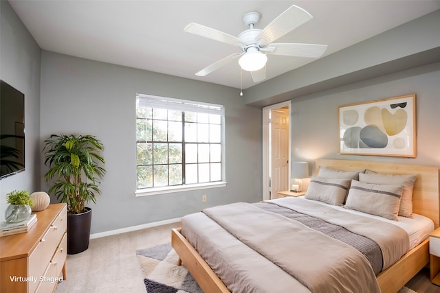 bedroom featuring light carpet and ceiling fan