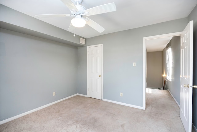 unfurnished bedroom with light carpet, a closet, and ceiling fan