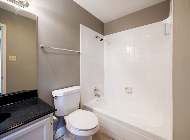 full bathroom with vanity, tiled shower / bath combo, and toilet