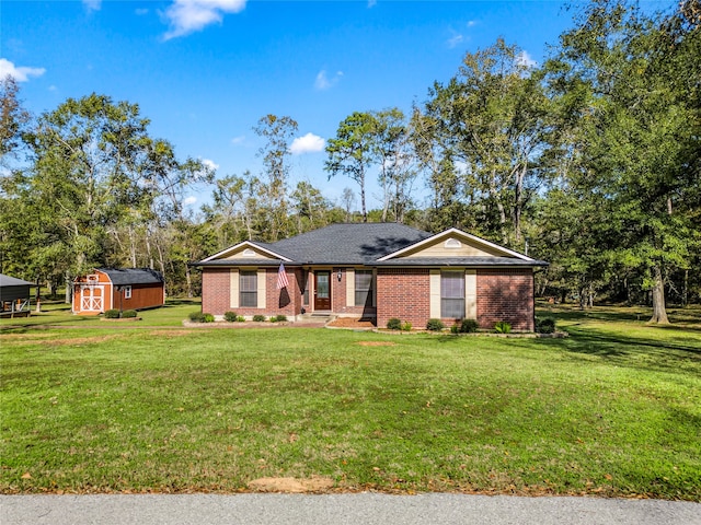 ranch-style home featuring a shed and a front lawn