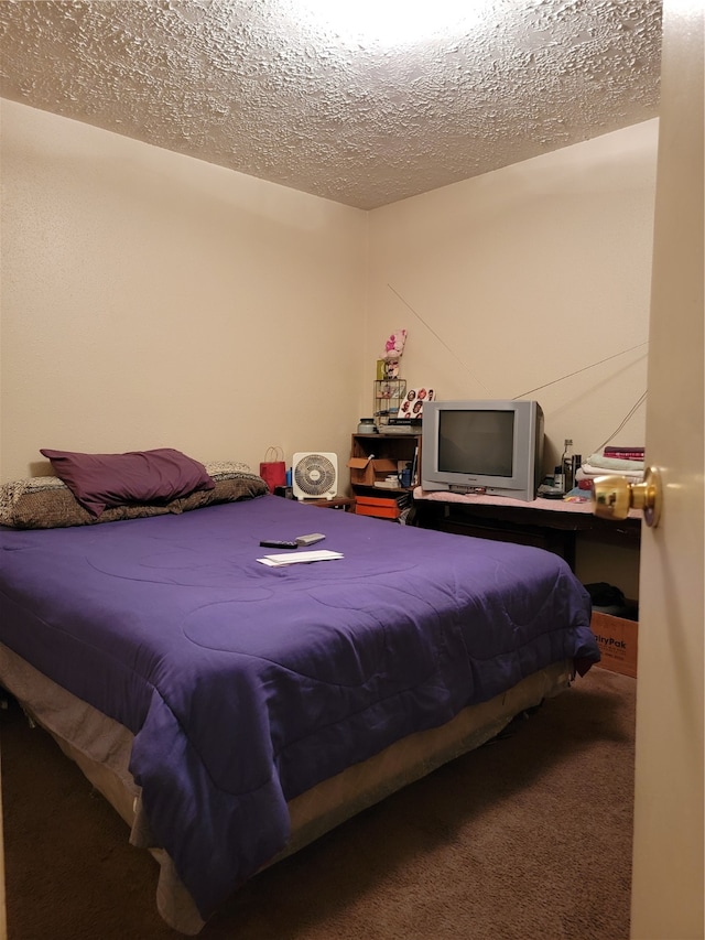 bedroom with carpet and a textured ceiling