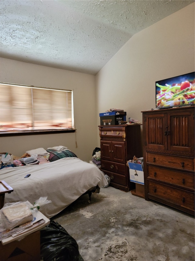 bedroom with a textured ceiling, light colored carpet, and vaulted ceiling