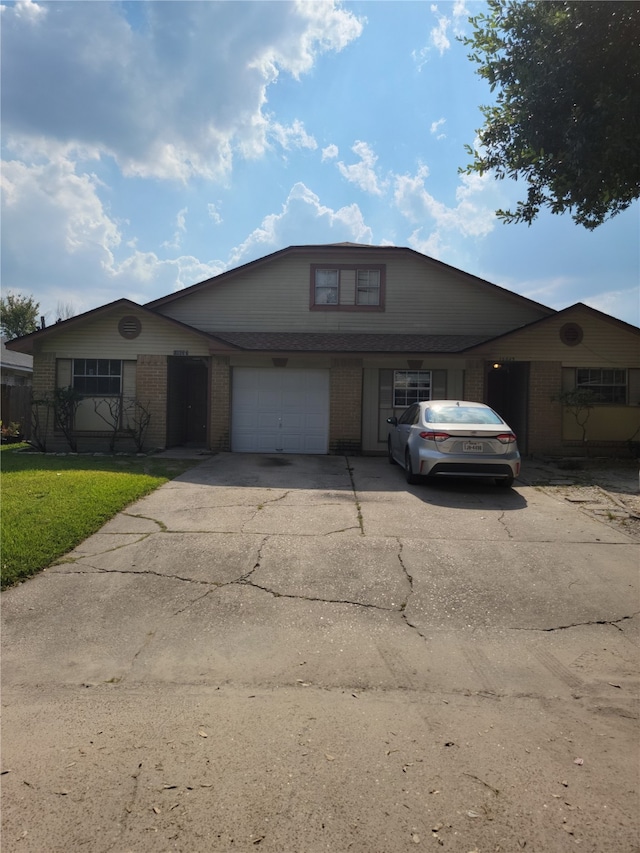 view of front of house with a front yard and a garage