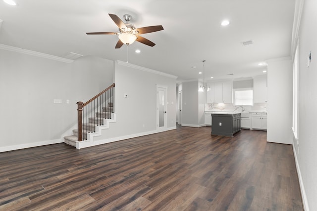 unfurnished living room with ceiling fan, dark hardwood / wood-style flooring, and crown molding