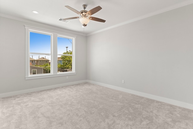 unfurnished room featuring carpet, ceiling fan, and crown molding