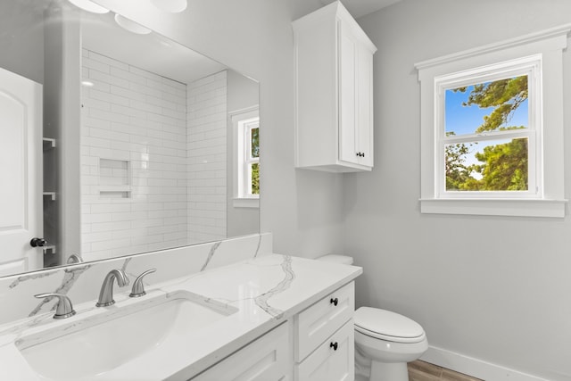 bathroom featuring wood-type flooring, vanity, and toilet