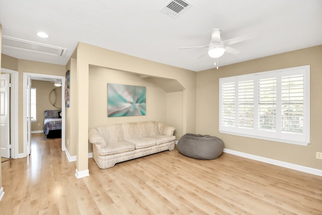 living room featuring ceiling fan and light hardwood / wood-style floors