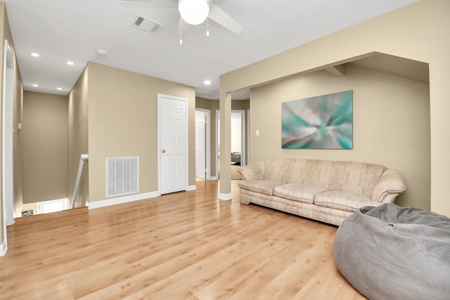 living room with ceiling fan and light wood-type flooring