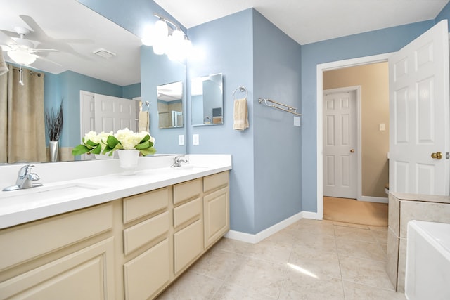 bathroom featuring vanity, tile patterned floors, ceiling fan, and a tub