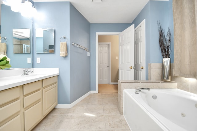 bathroom featuring tile patterned flooring, vanity, and a tub