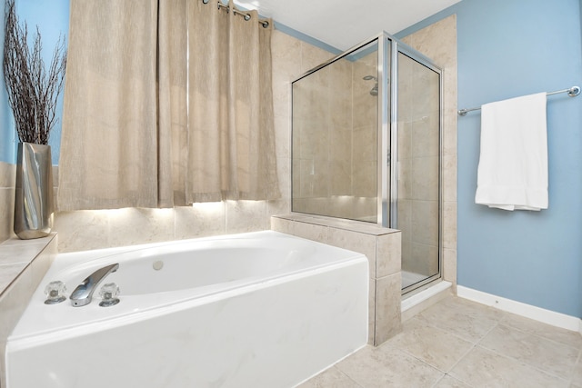 bathroom featuring tile patterned floors and separate shower and tub