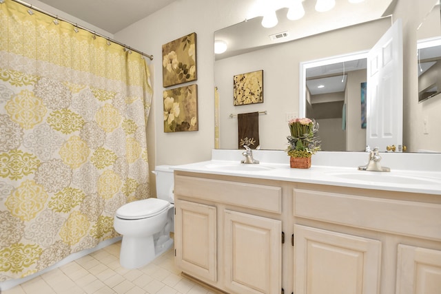 bathroom featuring tile patterned floors, vanity, and toilet