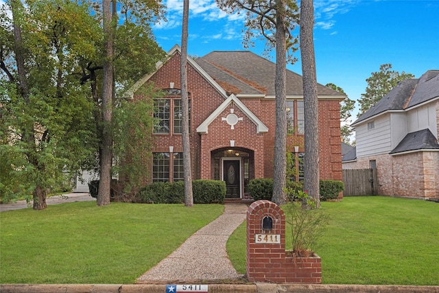 tudor home with a front yard