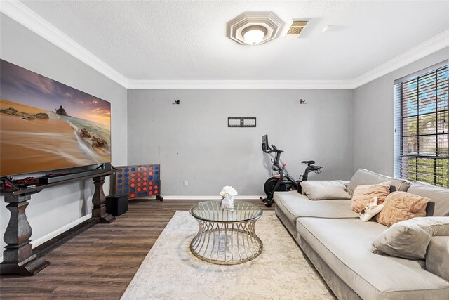 living room featuring a textured ceiling, dark hardwood / wood-style flooring, and ornamental molding