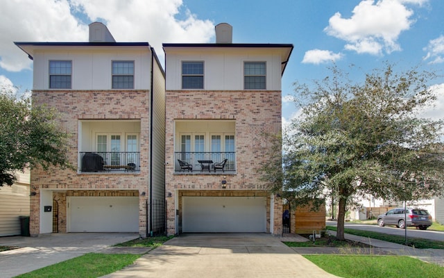 view of property featuring a garage and a balcony