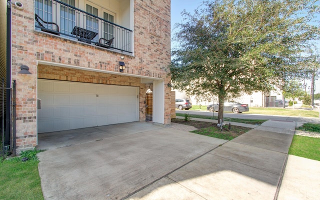 exterior space featuring a balcony and a garage