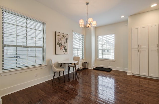 dining area featuring a notable chandelier and dark wood-type flooring