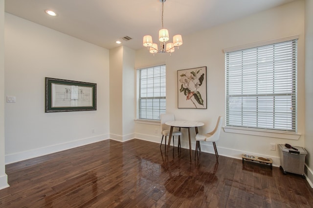 dining room featuring dark hardwood / wood-style floors and a chandelier