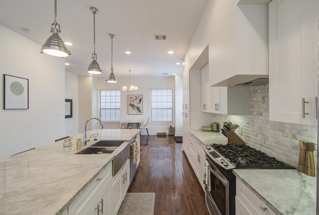 kitchen with decorative light fixtures, white cabinetry, dark wood-type flooring, and stainless steel range with gas stovetop