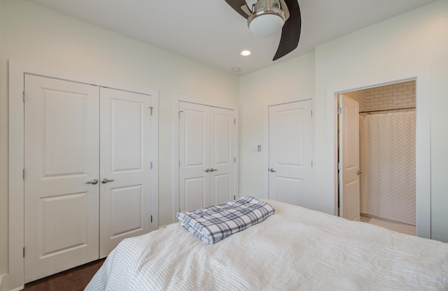 bedroom with multiple closets, ceiling fan, and dark wood-type flooring