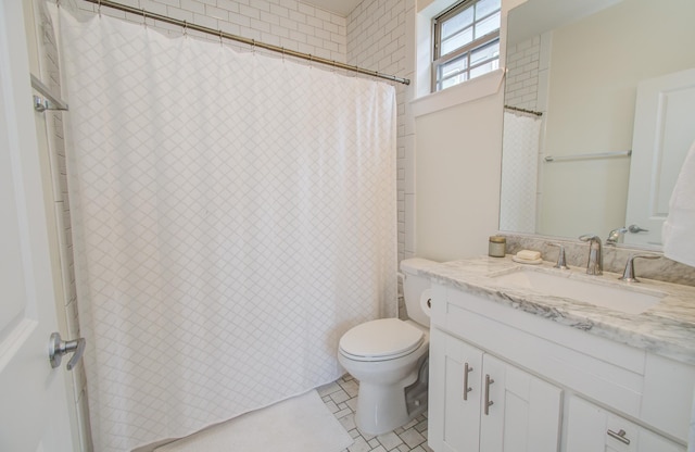 bathroom featuring tile patterned floors, vanity, and toilet