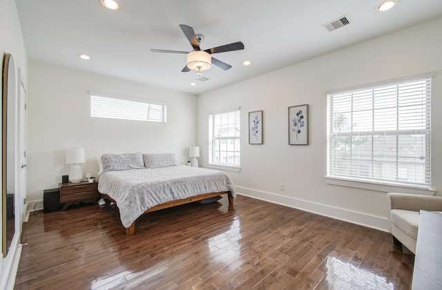 bedroom with dark hardwood / wood-style flooring and ceiling fan