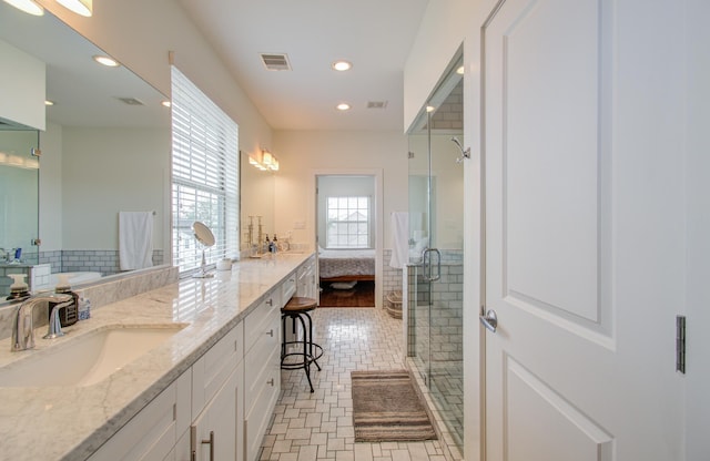 bathroom with a shower with door and vanity