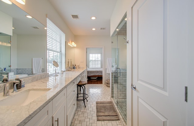 bathroom with vanity, tile patterned flooring, and a shower with shower door