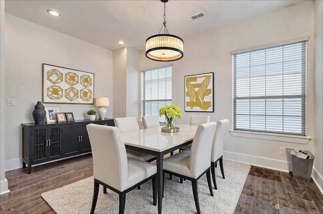 dining space with dark hardwood / wood-style floors