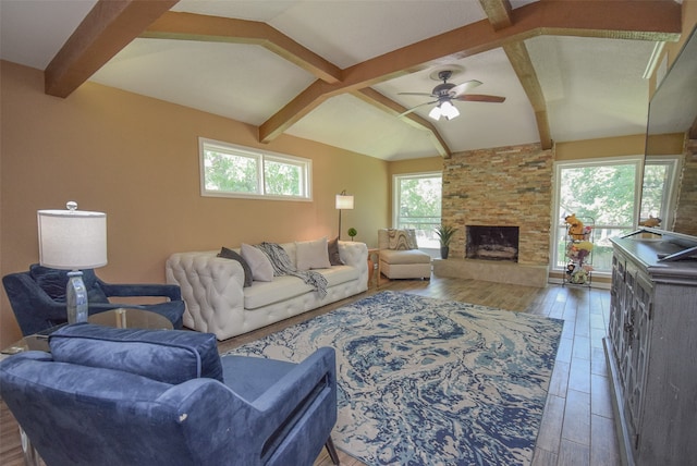 living room featuring a fireplace, vaulted ceiling with beams, dark hardwood / wood-style floors, and ceiling fan