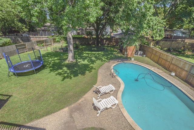 view of pool featuring a yard and a trampoline