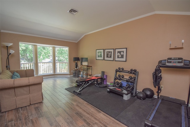 workout area with hardwood / wood-style floors, lofted ceiling, and crown molding