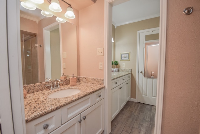 bathroom with vanity, ornamental molding, and hardwood / wood-style flooring