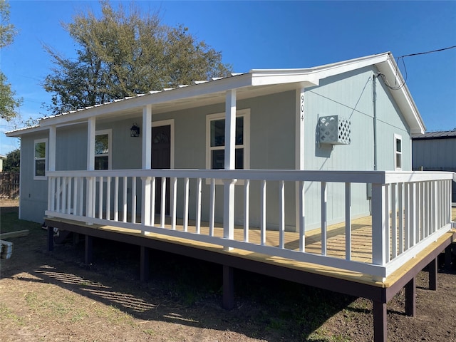 back of house with a deck