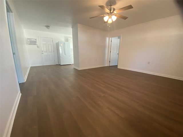 spare room featuring an AC wall unit, ceiling fan, and dark hardwood / wood-style floors