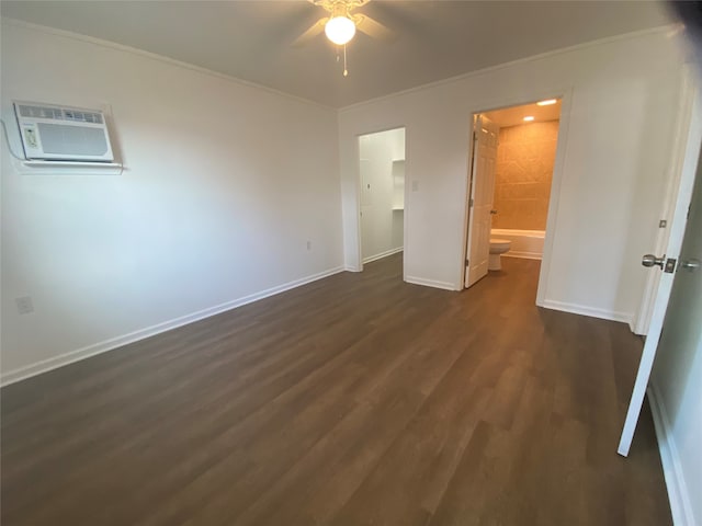 unfurnished bedroom with a wall mounted air conditioner, ornamental molding, ceiling fan, connected bathroom, and dark hardwood / wood-style floors