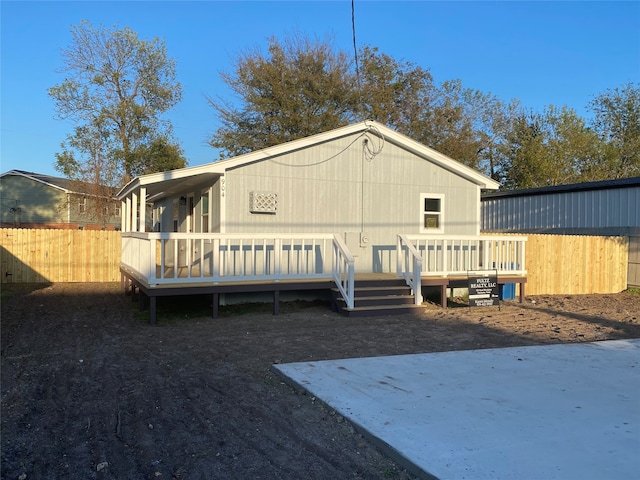 back of house featuring a wooden deck