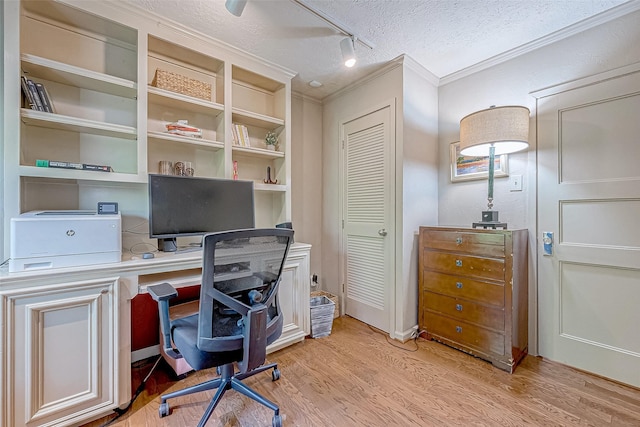 office area featuring track lighting, ornamental molding, a textured ceiling, and light wood-type flooring