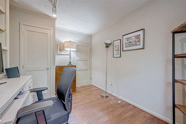 office space with light hardwood / wood-style flooring, ornamental molding, and a textured ceiling