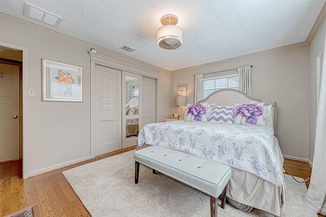 bedroom featuring hardwood / wood-style flooring and crown molding