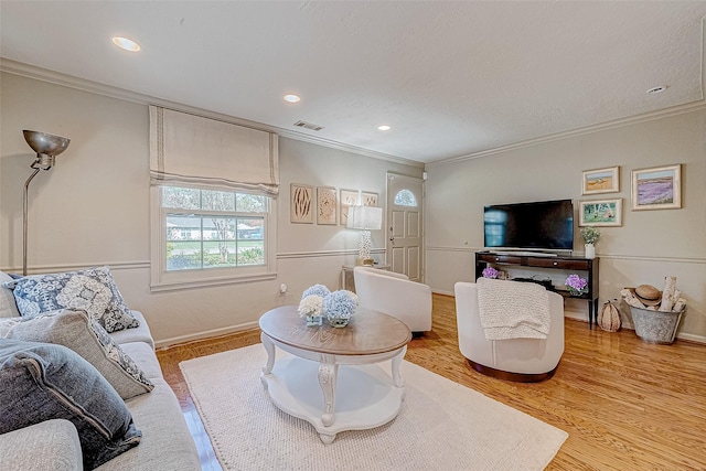 living room featuring ornamental molding and hardwood / wood-style floors